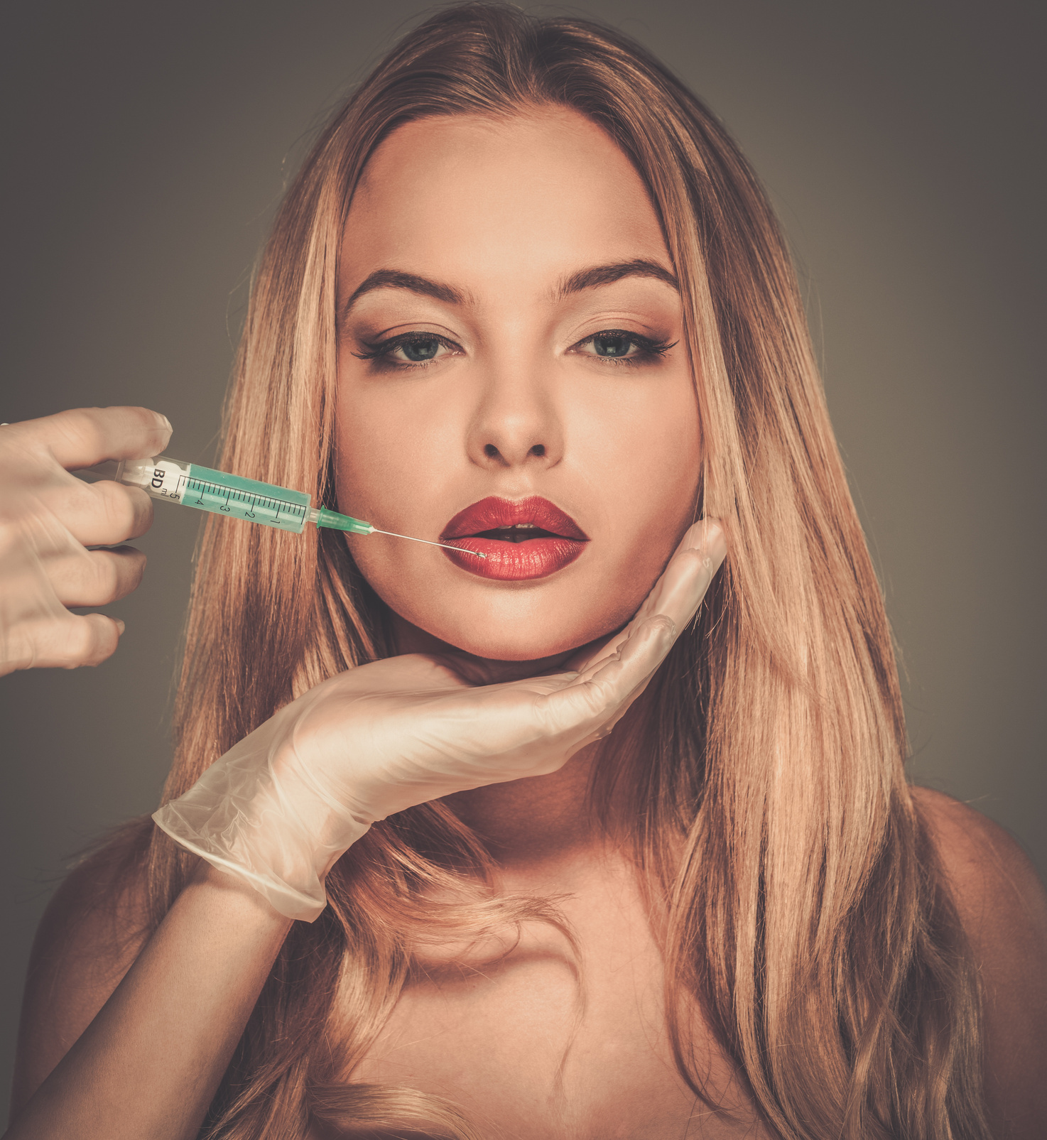 Woman with Red Lips Having an Injection